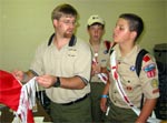 An Arrowman learns more about how to construct dance outfits from a trainer.