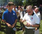 National Chairman Brad Haddock signs a Kansa Lodge member's souvenir log slice