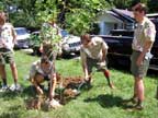 National Chief Clay Capp shovels dirt at the tree planting as National Vice Chief Riley Berg and the Region Chiefs watch