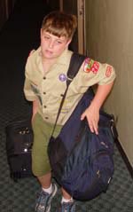 Arrowman carrying his bags in a residence hall